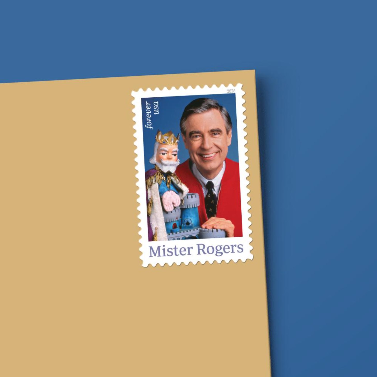 A mockup of a tan envelope with a Mister Rogers forever stamp on the upper right corner