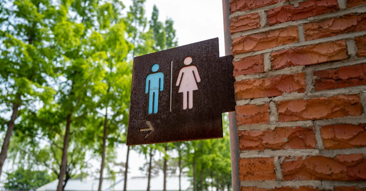 A restroom sign showing a male and female symbol