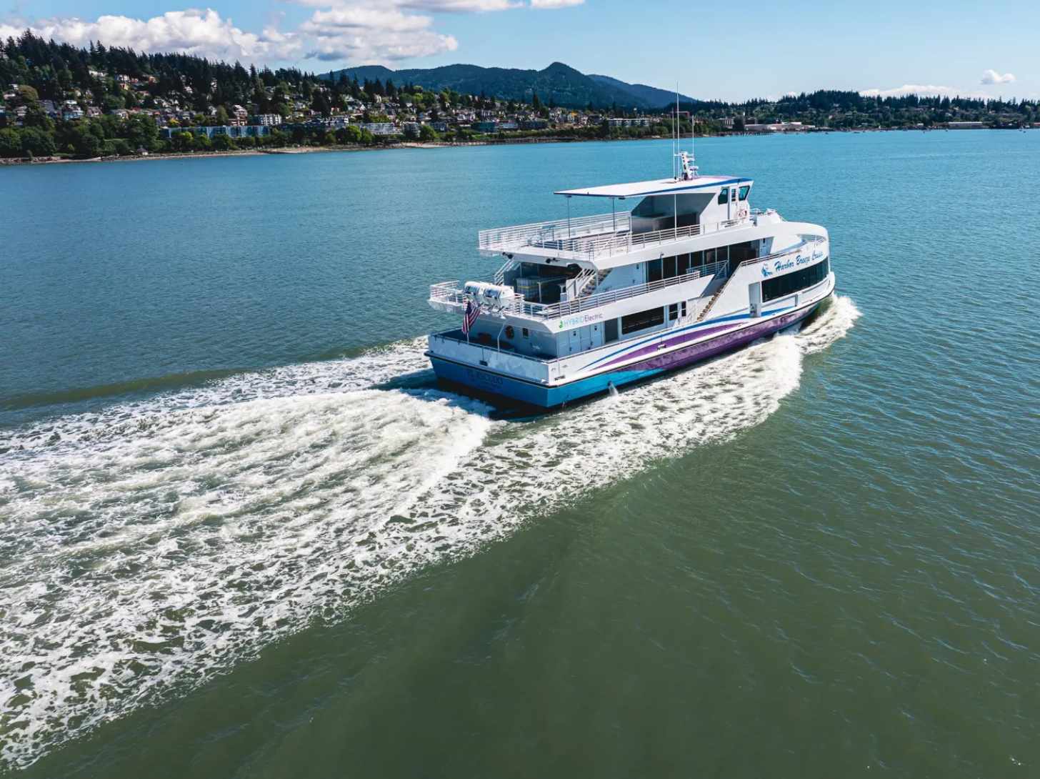 A boat photographed from a distance, on the water, called El Escudo