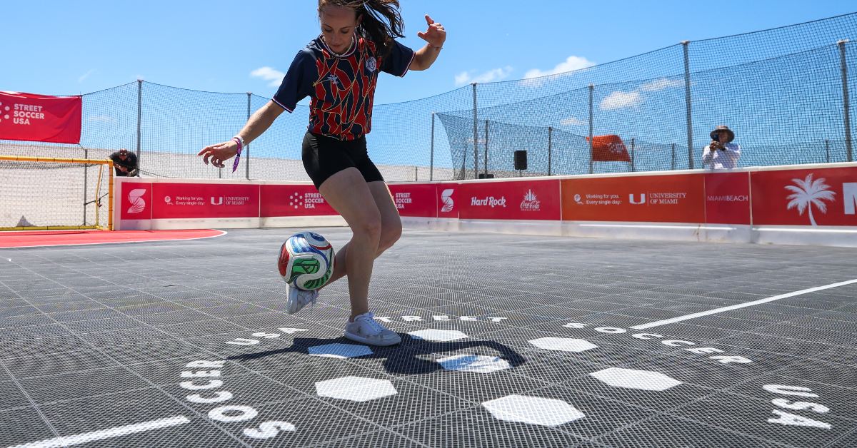 A female athlete juggles a soccer ball at a playpark in Miami