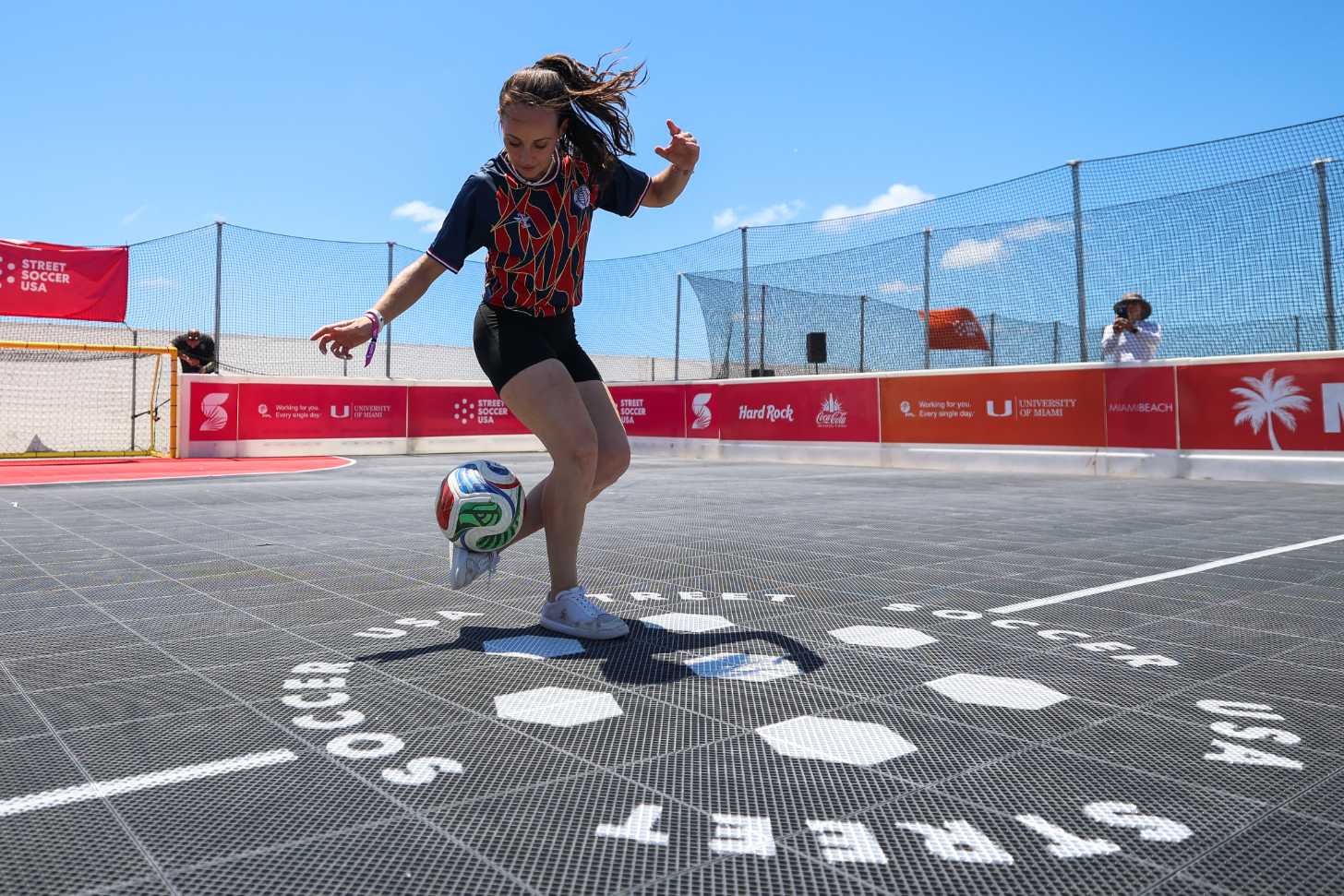 A female athlete juggles a soccer ball at a playpark in Miami