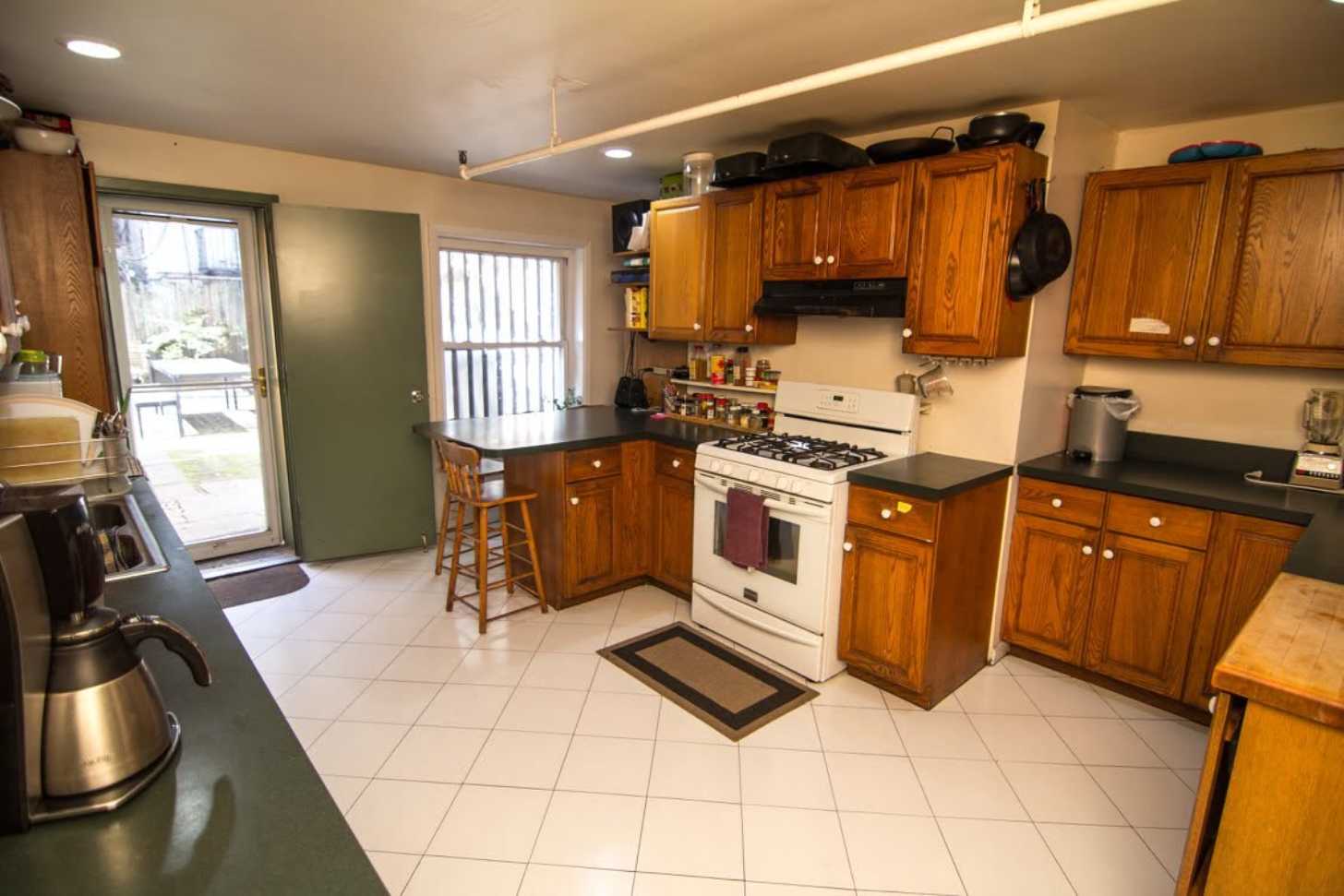 A kitchen with wooden cabinets in Menno House, in Manhattan, NYC