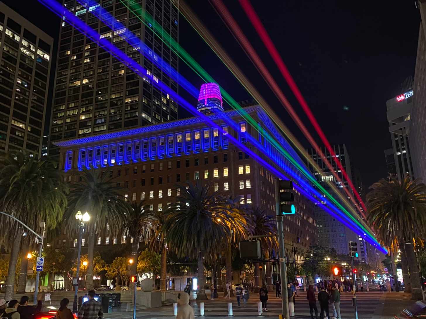Rainbow lights beam down a street in San Francisco