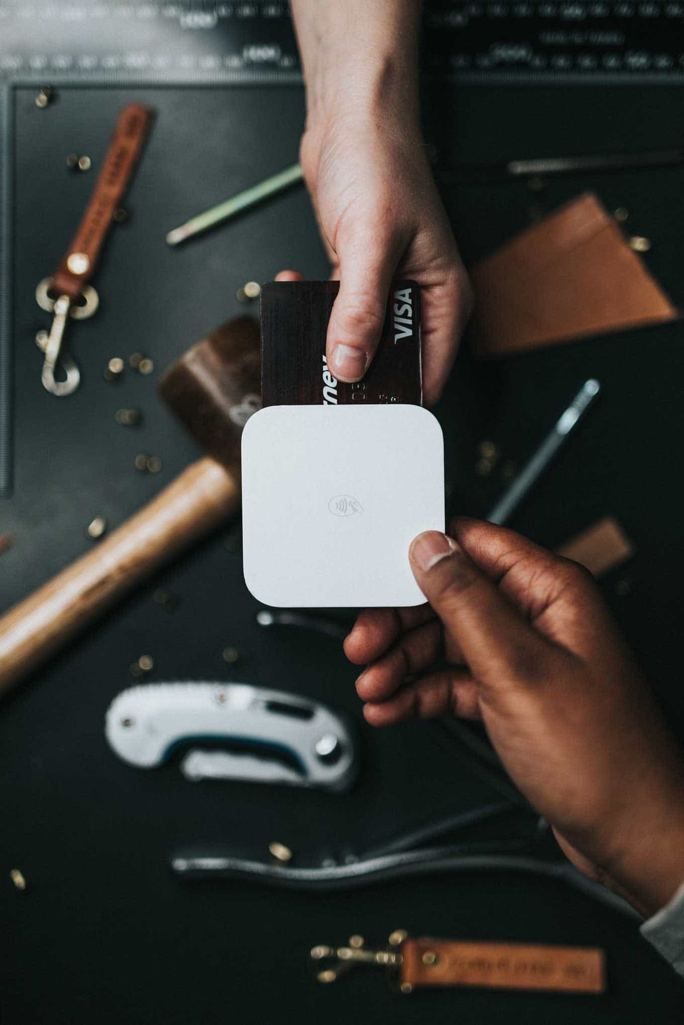 A customer pays a small business owner by credit card with a Square reader