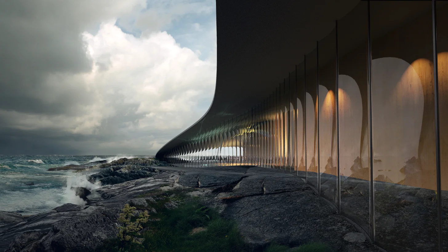 A modern curved structure with vertical metal columns and translucent panels sits on rocky coastline beside ocean waves, with cloudy sky above.