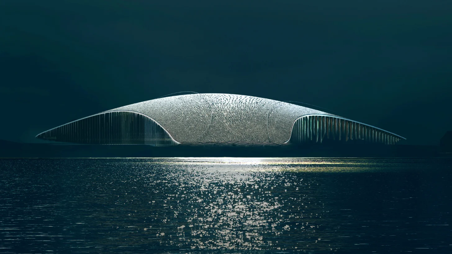 A large white sculptural structure with a curved, ribbed design floats above calm water under a dark teal sky, with sunlight reflecting off the water's surface below.