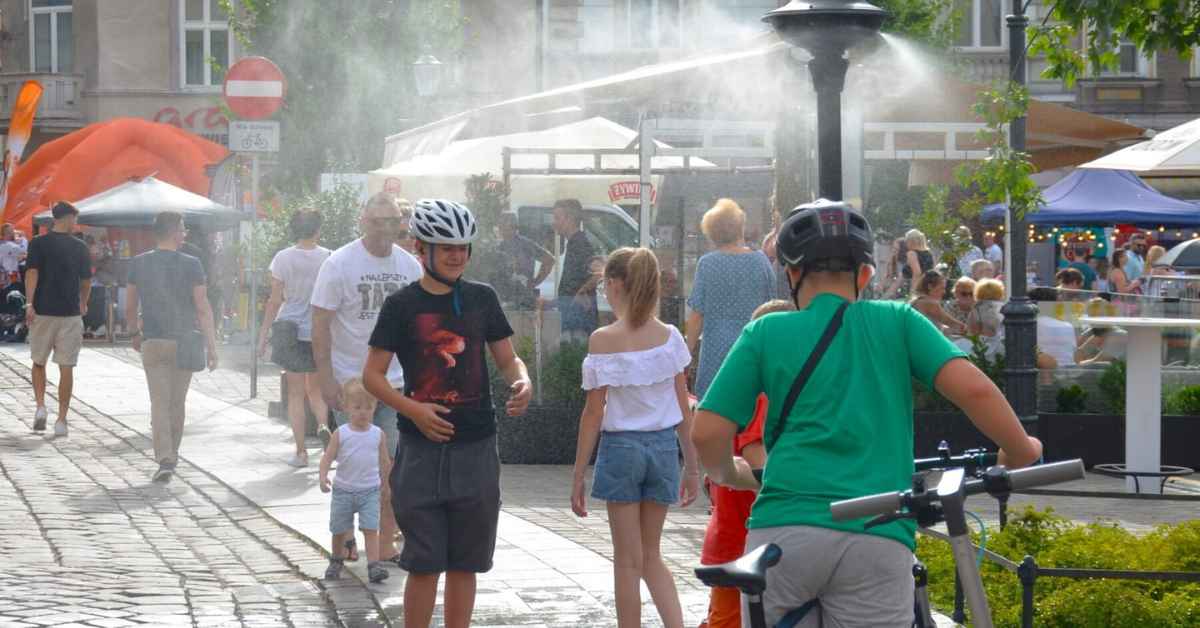 Residents of Bielsko-Biała, Poland, walk through sprinklers to stay cool during a heat wave