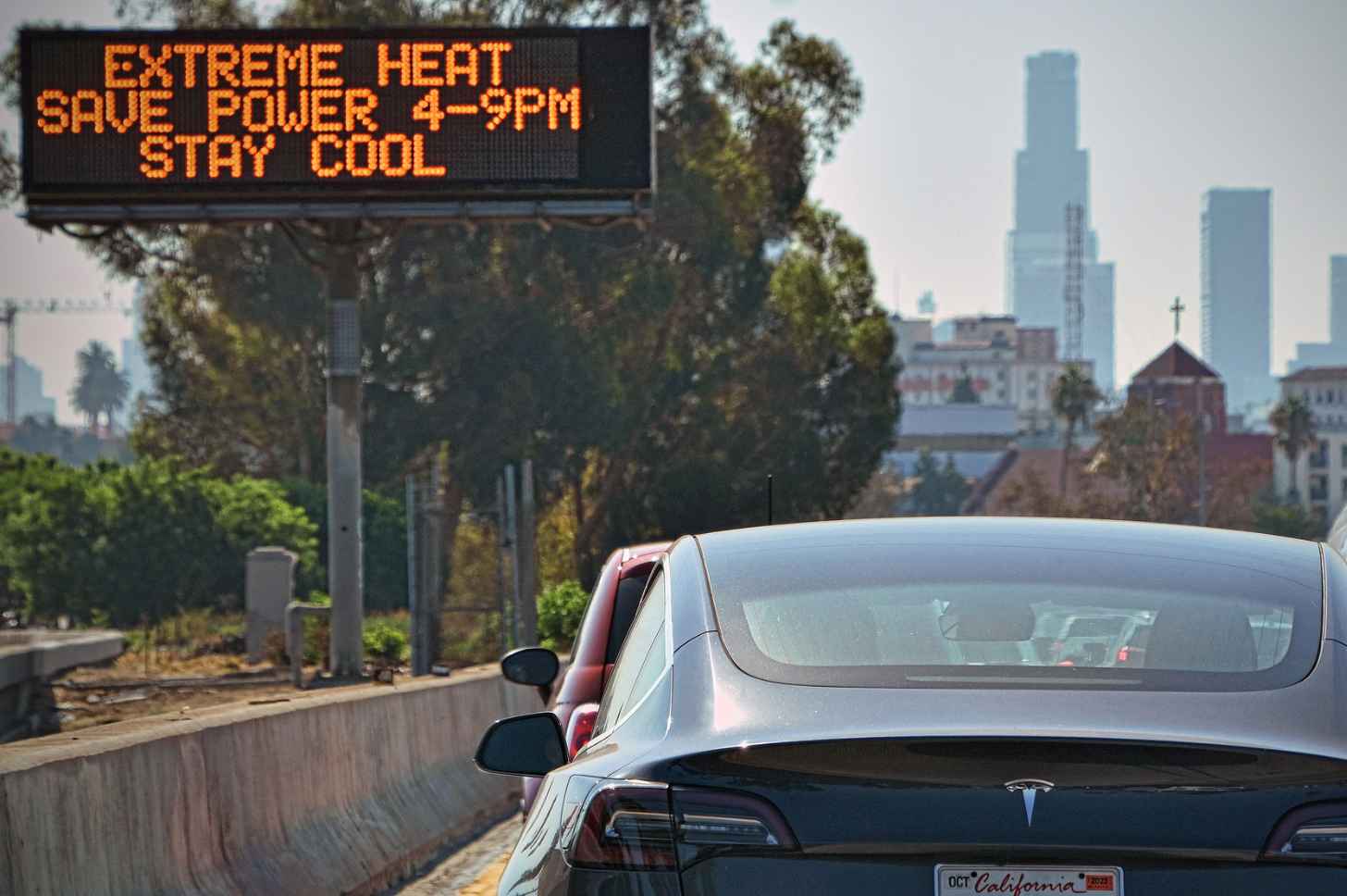 Cars pass an extreme heat warning in California. Urban heat island impacts are especially devastating to the health of vulnerable populations. 