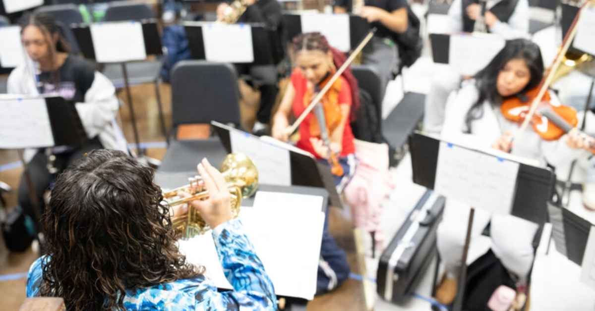 Music teacher Danielle Trial Lucini accompanies students on the trumpet during her first-period Concert Band class at Mount Pleasant High School