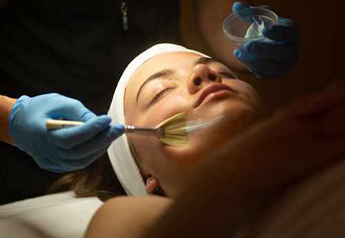 Young woman having facial treatment