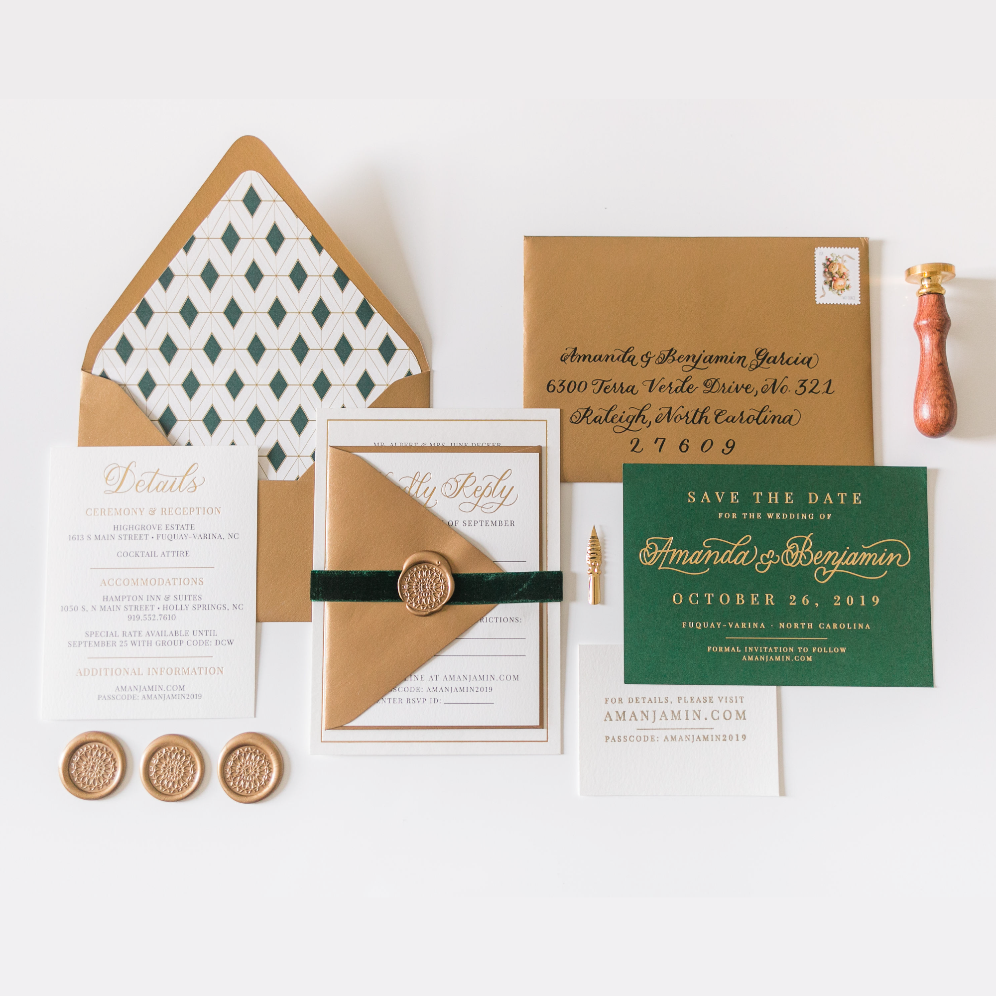 A photo of a wedding invitation suite with gold envelopes and white and green paper. There is also three gold wax seals and a wax stamper in the frame.