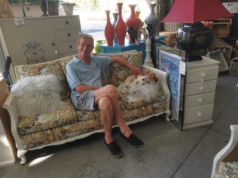 Glenn McDean sitting on Upcycled Couch with Dog.