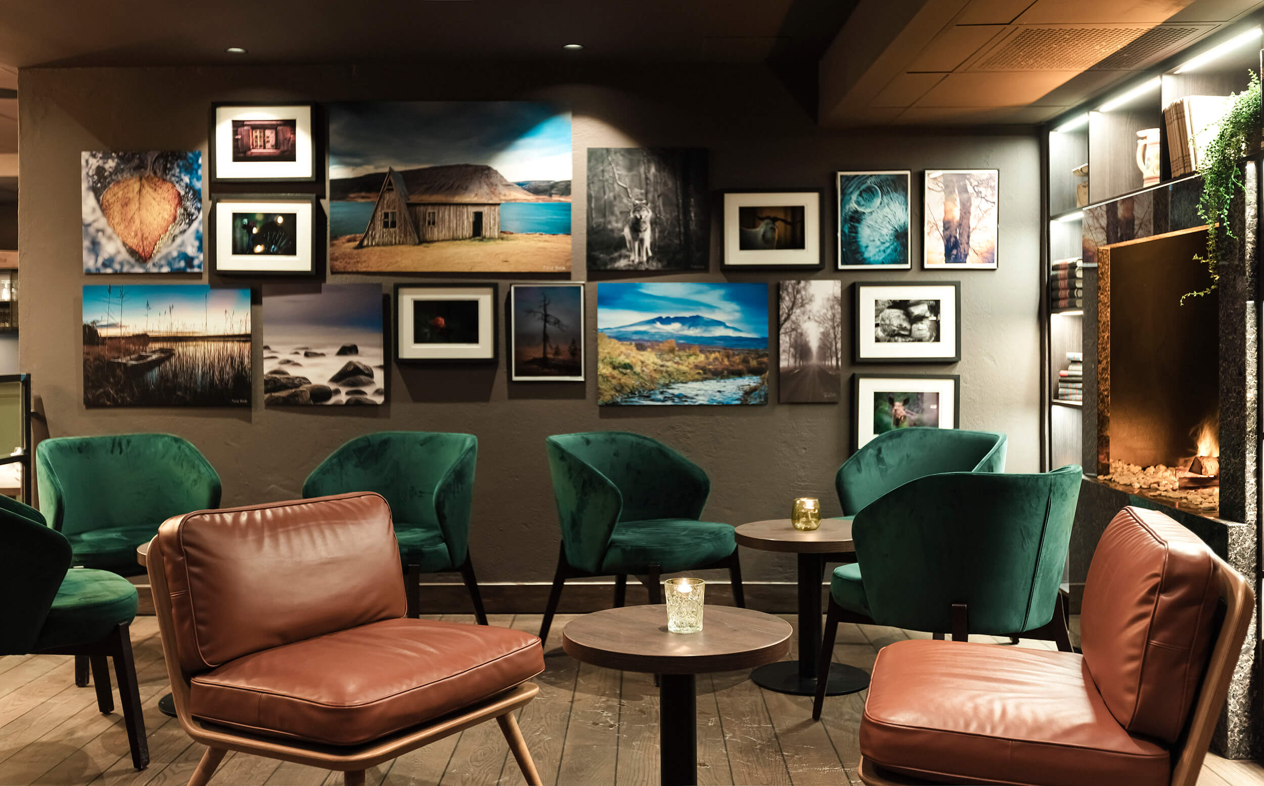 Vintage lounge stolar ved vegg med bilete.
Vintage lounge chairs by photo collage wall.