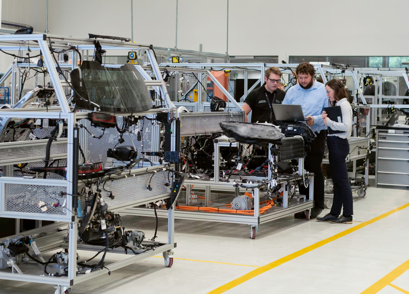 Female electronics engineer tests vehicle software with team