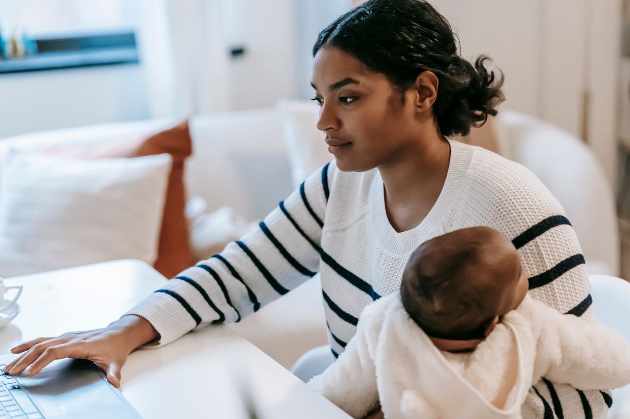 nontraditional student pursuing her masters online with her infant on her lap