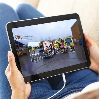 A person sitting on a couch holding a tablet.