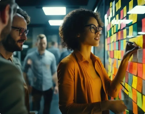 A group of people standing around a colorful wall.