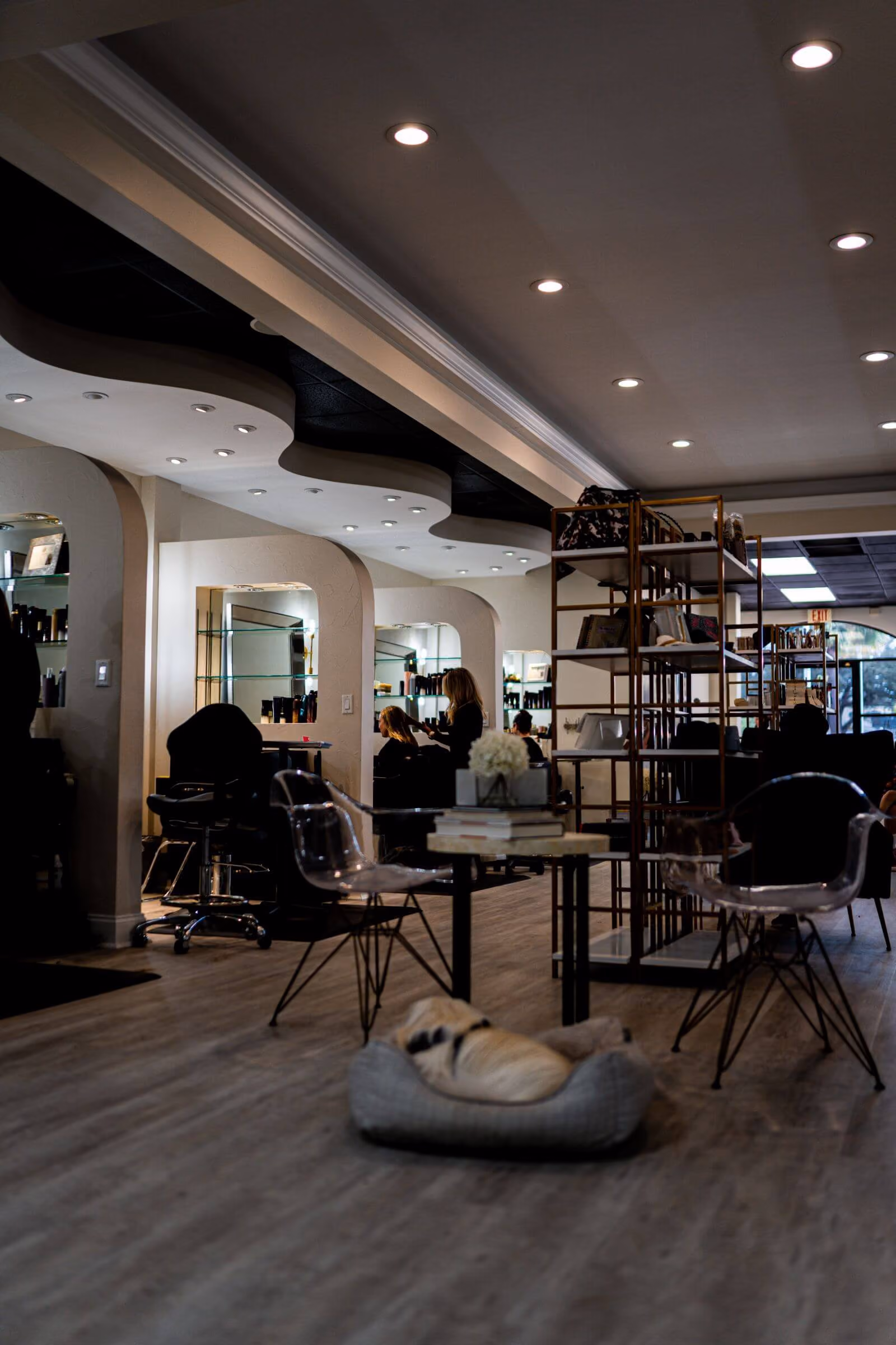 Interior of Janelle Alexis Salon in Tanglewood near the Houston Galleria, with arched mirror styling stations and clear acrylic chairs