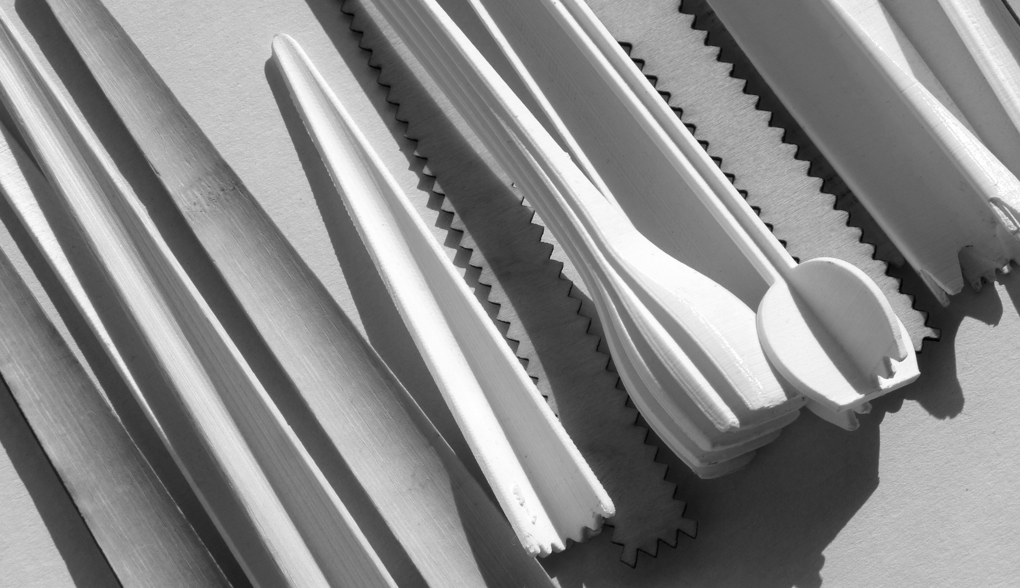 Lots of 3D printed and lasercut prototypes pf a cocktail stamper each with a different shape.