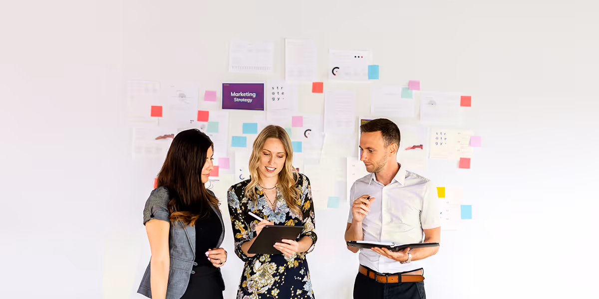 three people comparing notes