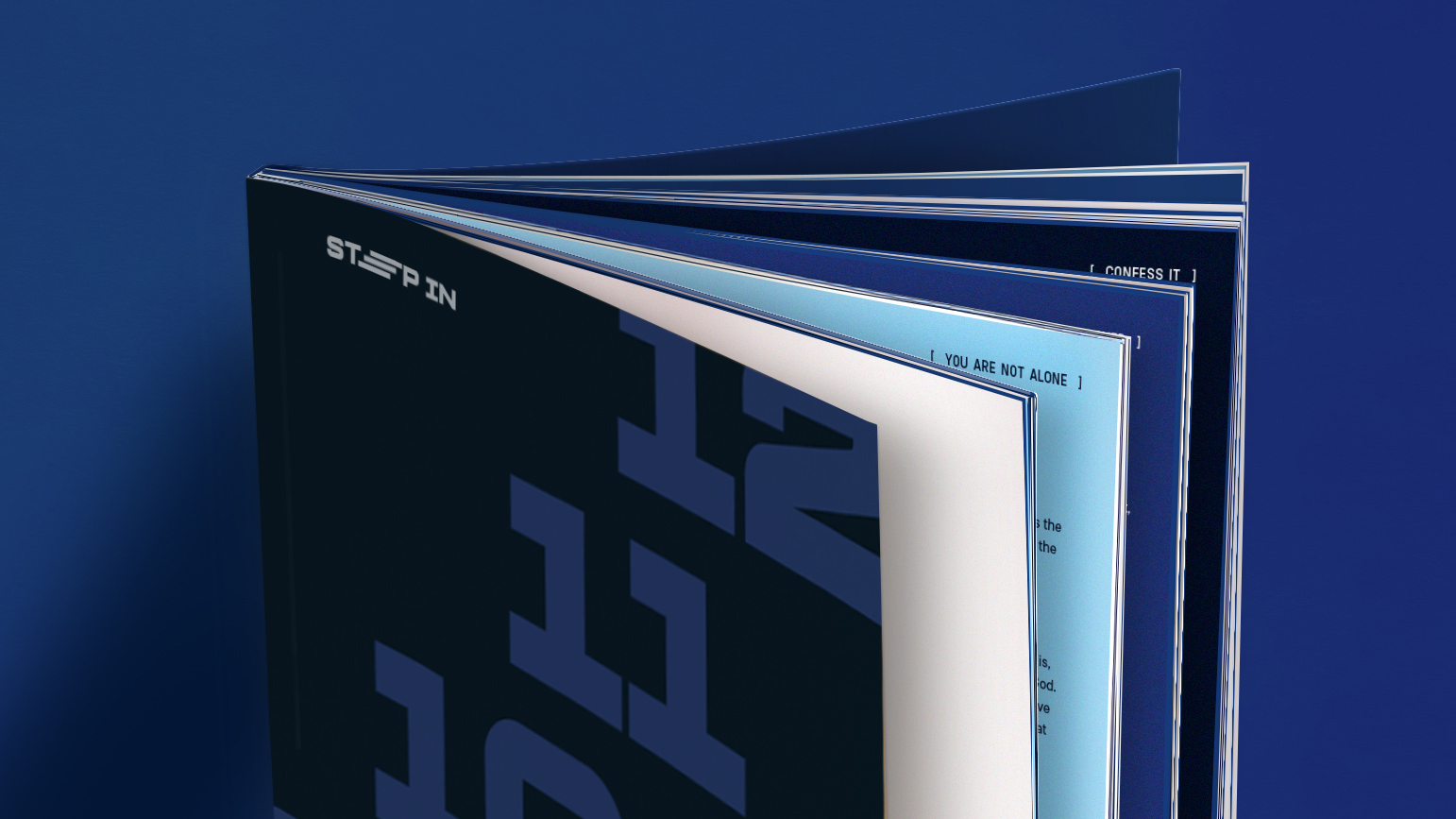 Close-up of an open booklet with dark cover and partially visible text on blue and white pages.