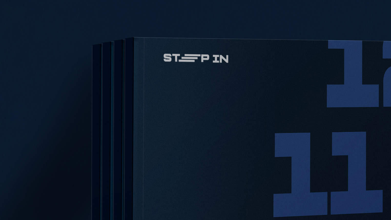 Close-up of stacked dark blue boxes with the text 'STEP IN' on the front and large numbers partially visible on the side.