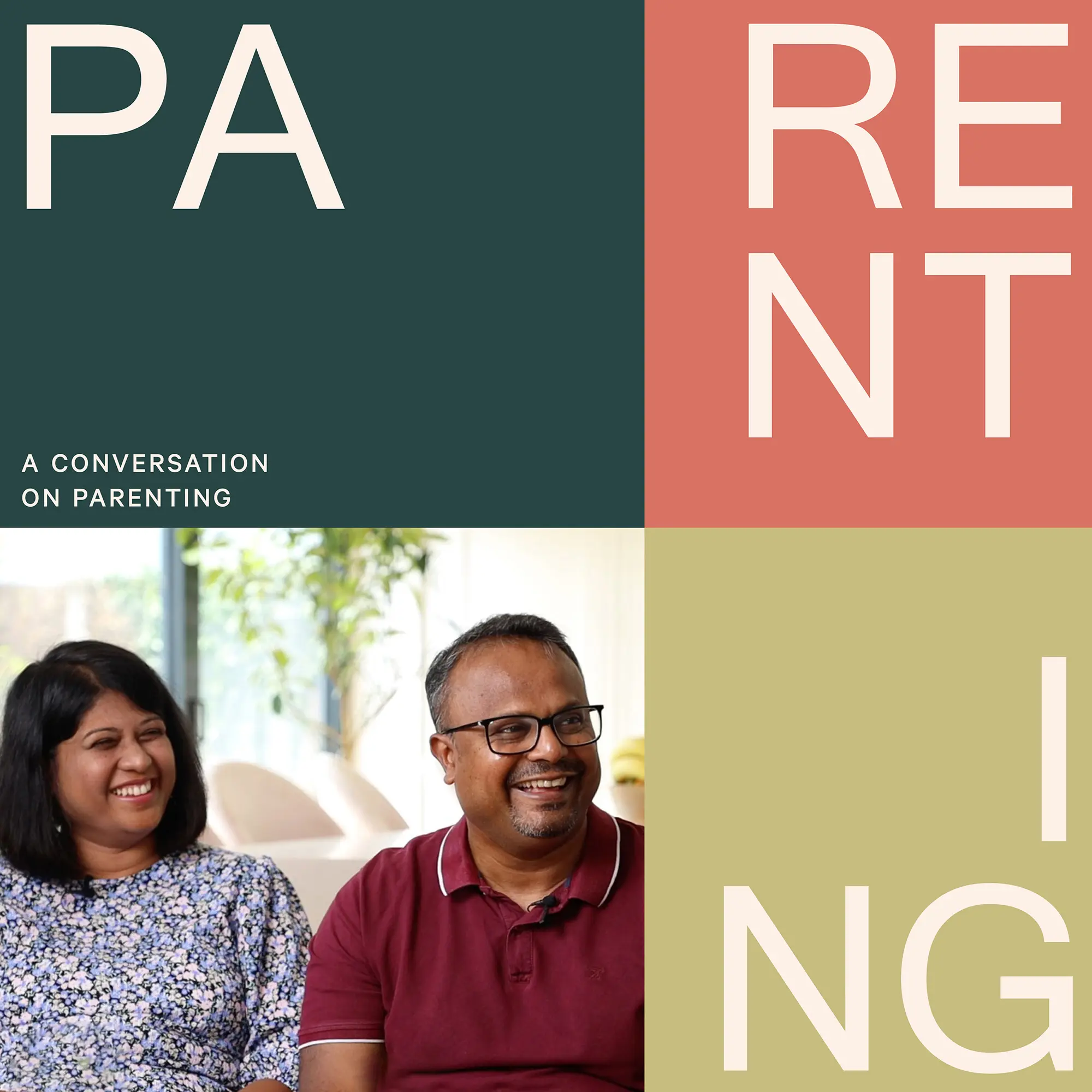 Smiling man in glasses and maroon shirt and woman in floral top sitting indoors with text blocks spelling PARENTING and subtitle 'A conversation on parenting'.