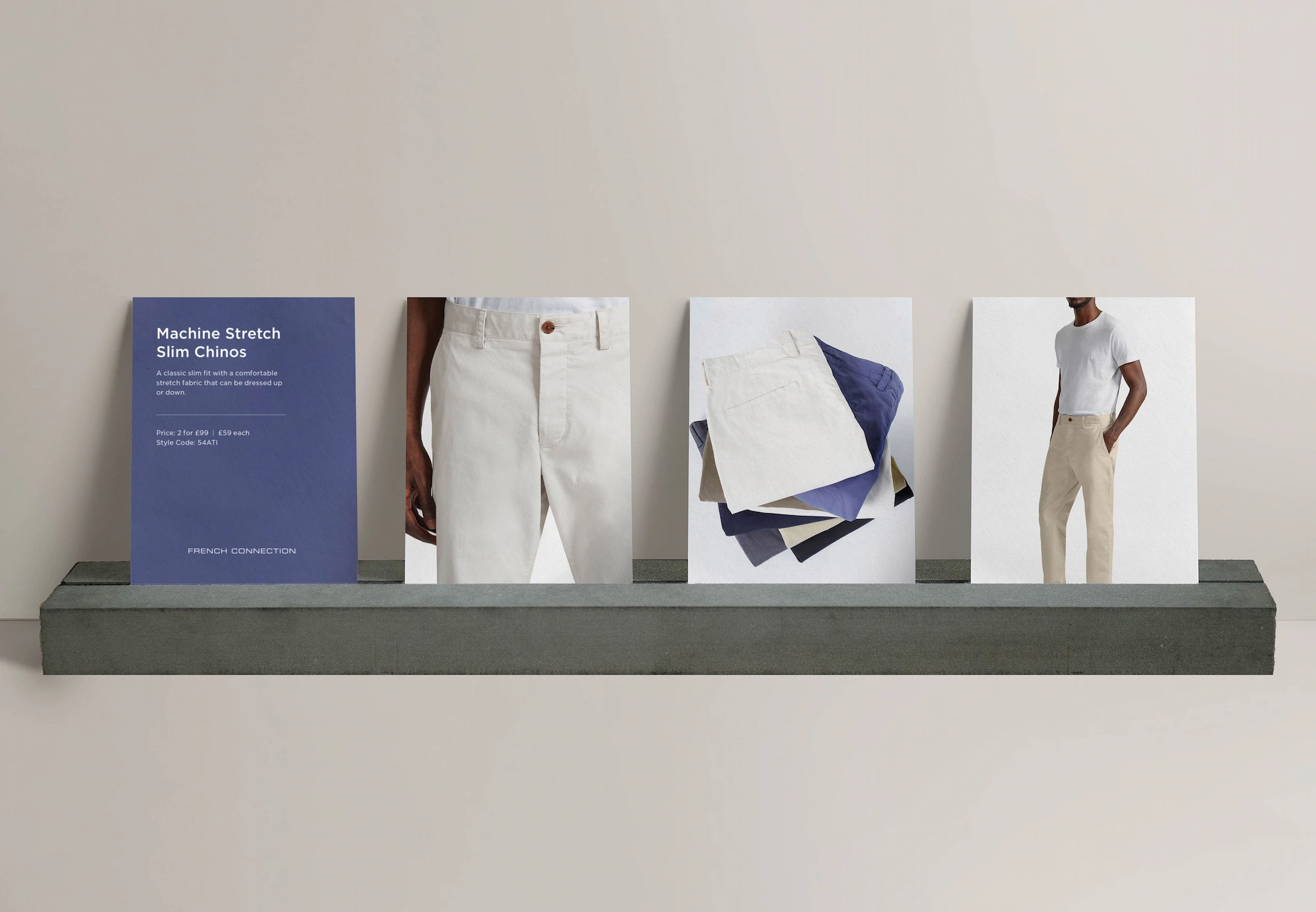 Display of Machine Stretch Slim Chinos with product card and varied folded pants in neutral and blue tones.