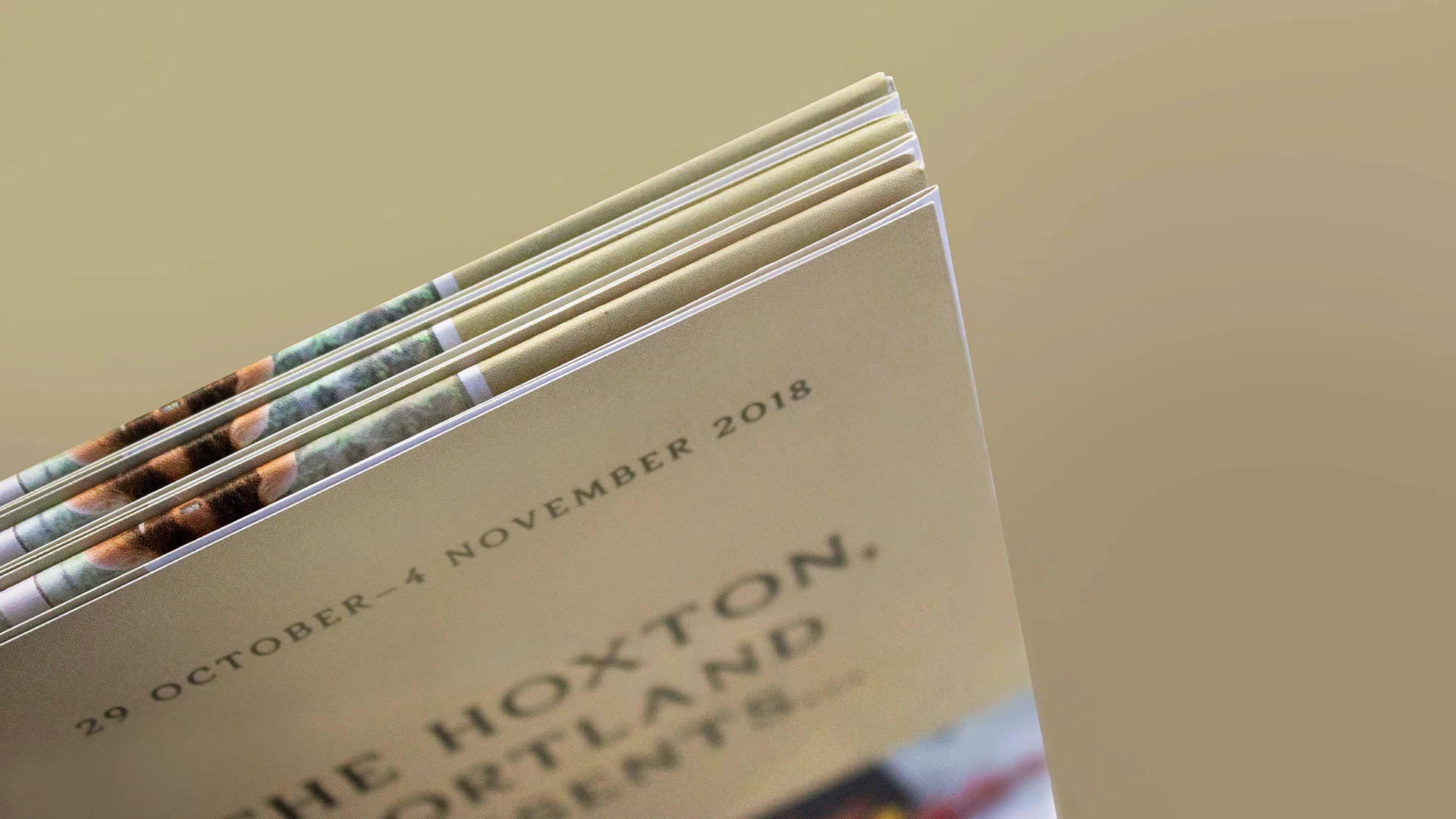 Folded booklet showing text '9 October - 4 November 2018' with blurred title 'The Hoxton, Portland, Presents'.