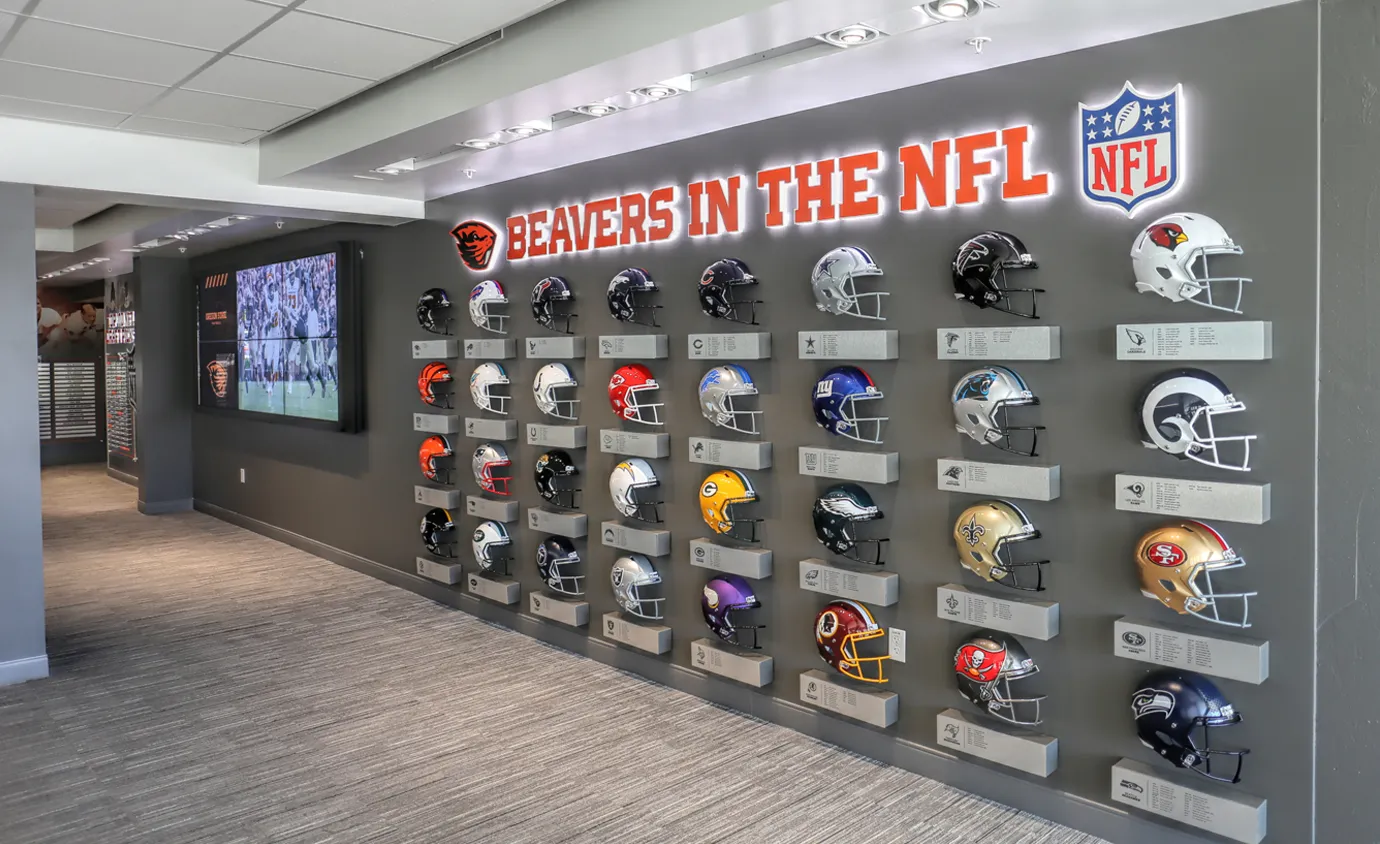 Foot ball helmet display wall created by Infinity Images