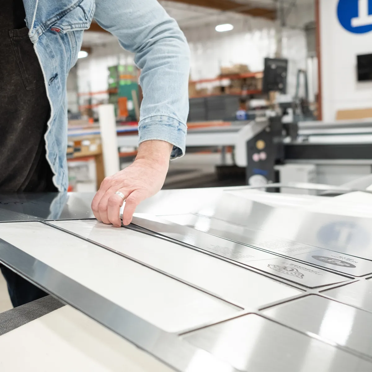 Infinity Images employee cutting sign materials