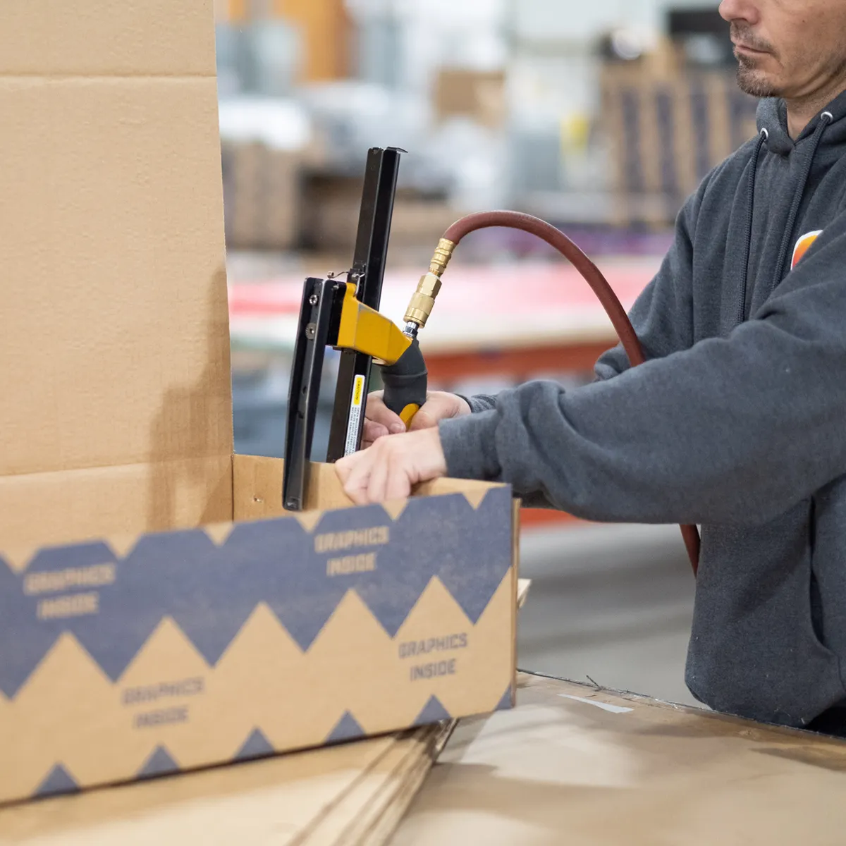 Infinity Images employee creating a box