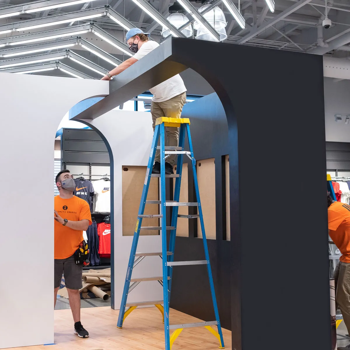 Infinity Images employee installing a retail display