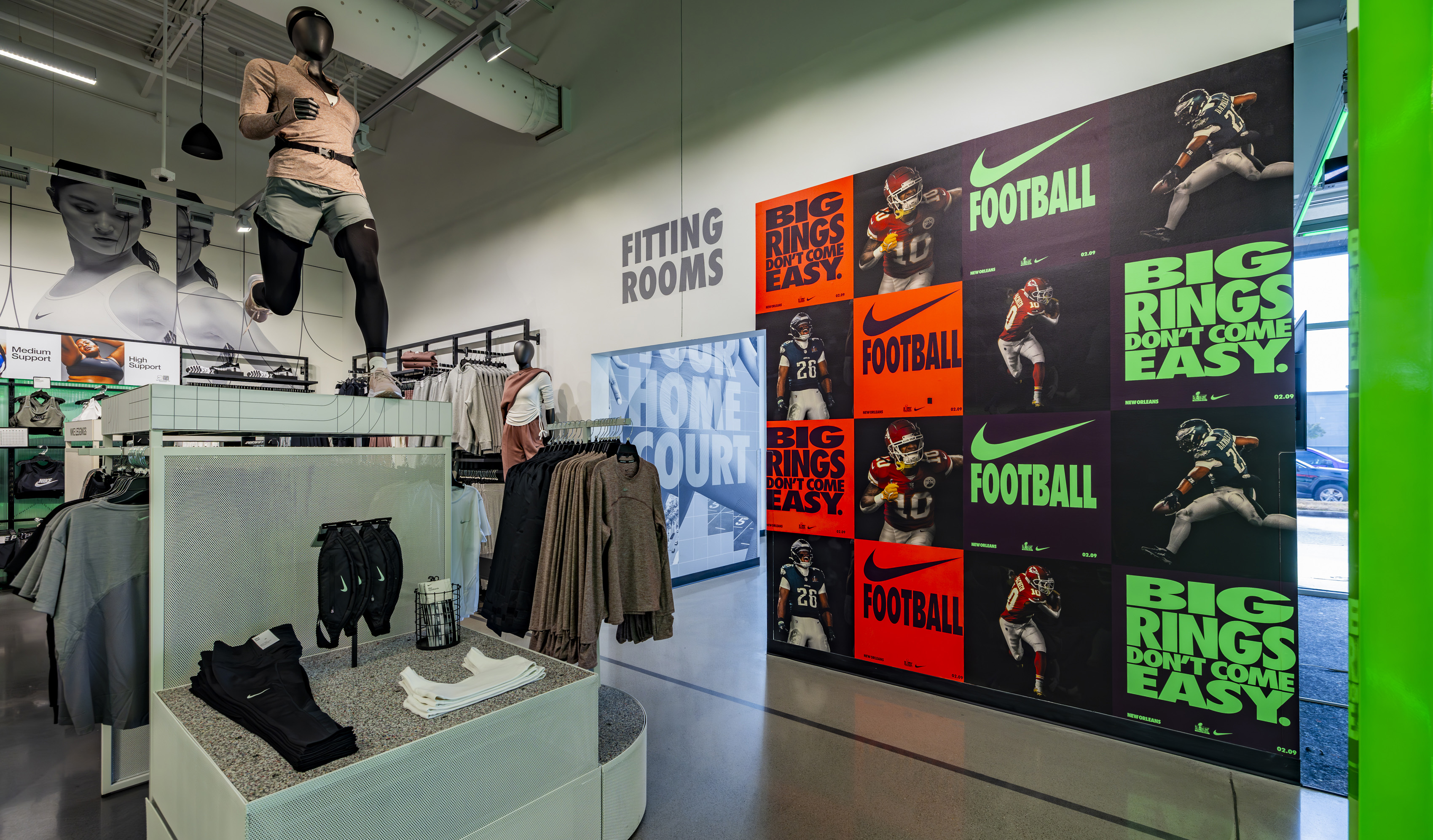 Wall covered in Nike Football neon posters.