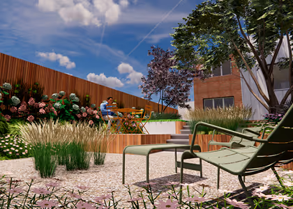 Modern outdoor garden with green lounge chair and footrest on pebble ground, wooden fence, flowering plants, and two people sitting at a wooden table under a blue sky with clouds.