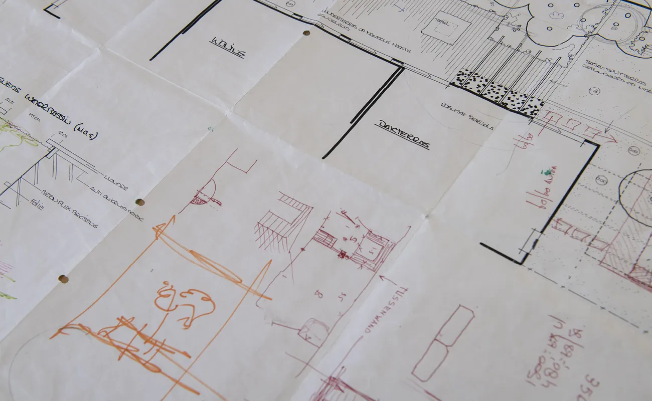 Architectural blueprint with black, red, and orange annotations and measurements on white paper.