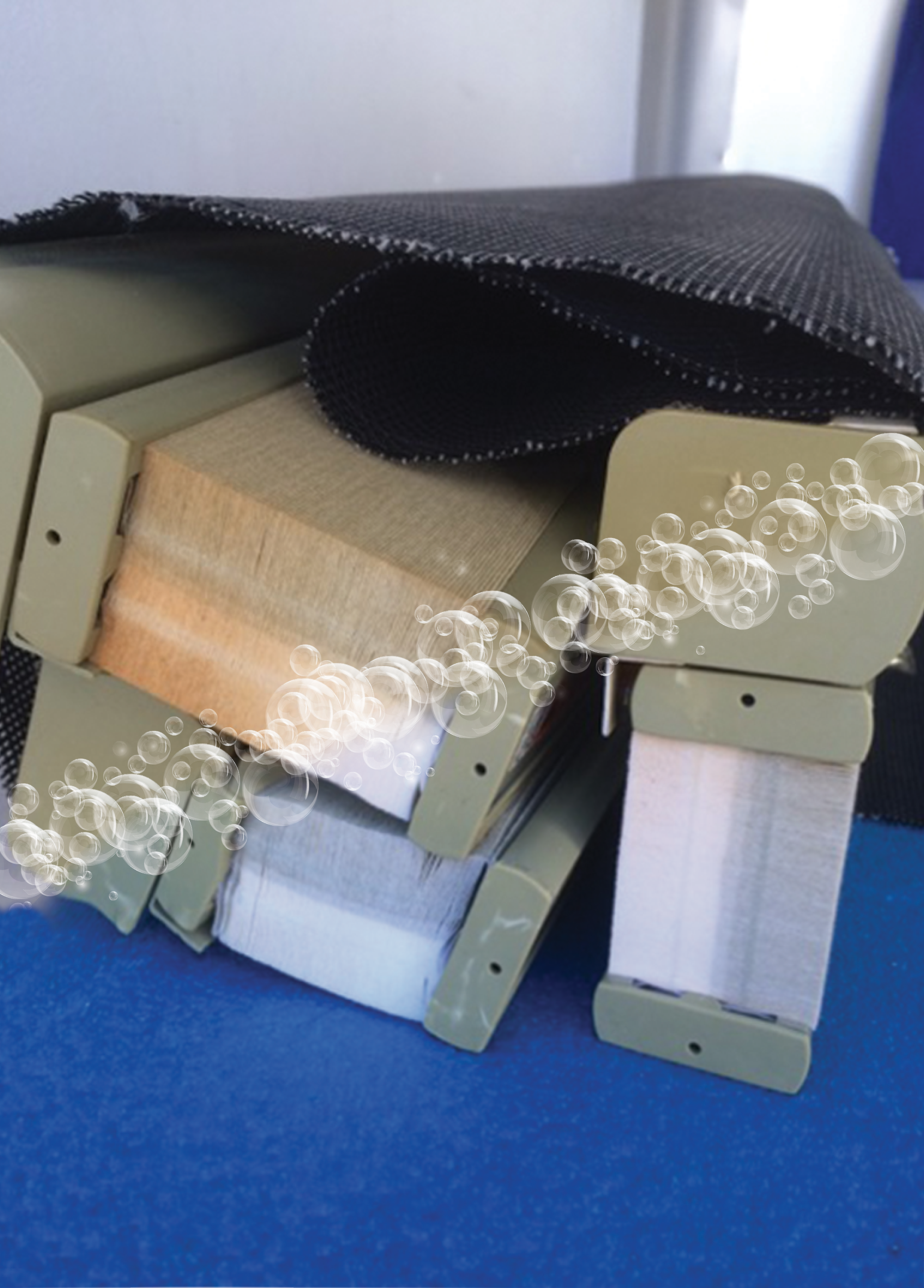 3 sets of honeycomb blinds sit with a line of bubbles dividing dirty orange blinds and cleaned white blinds