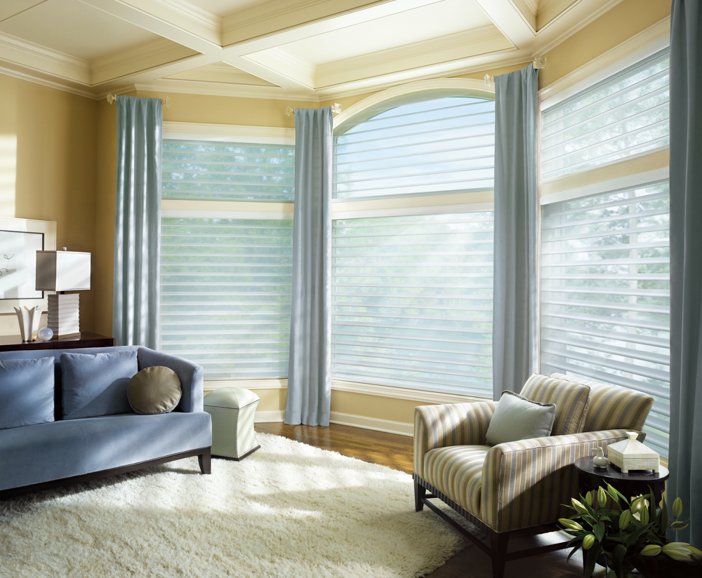 a triple bay window of Silhouette sheer blinds lets in beautiful natural light to your home