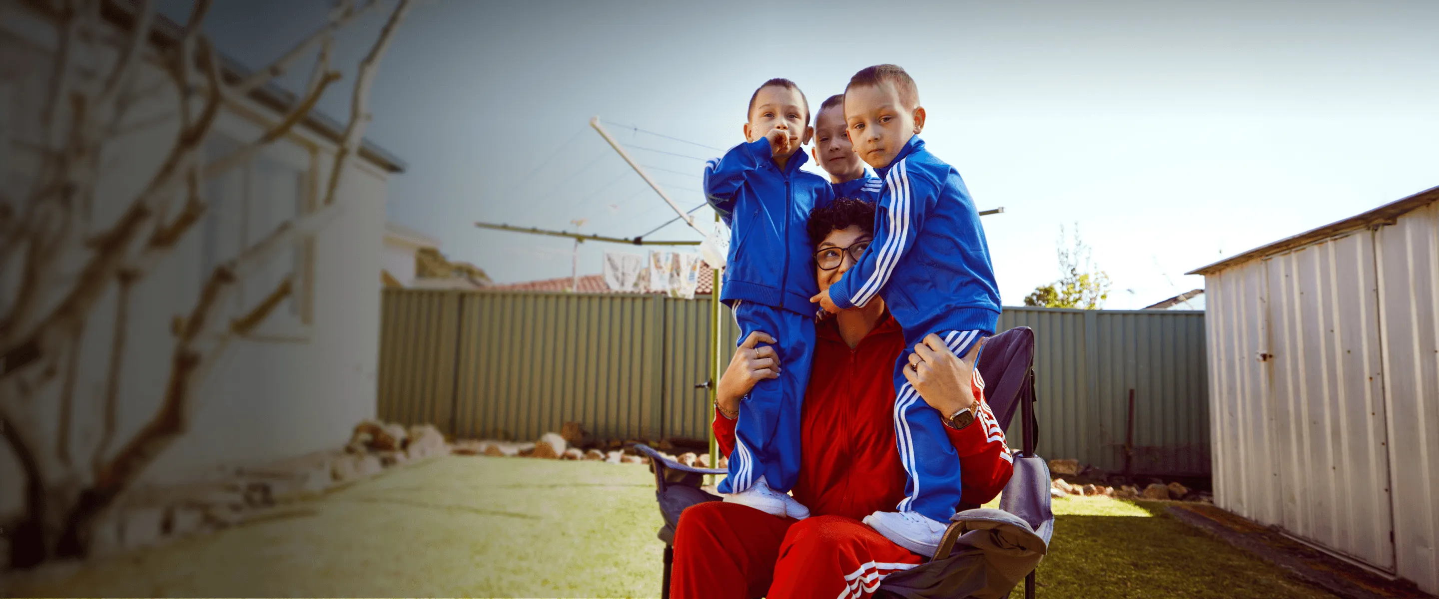 A mum with her 3 boys sitting