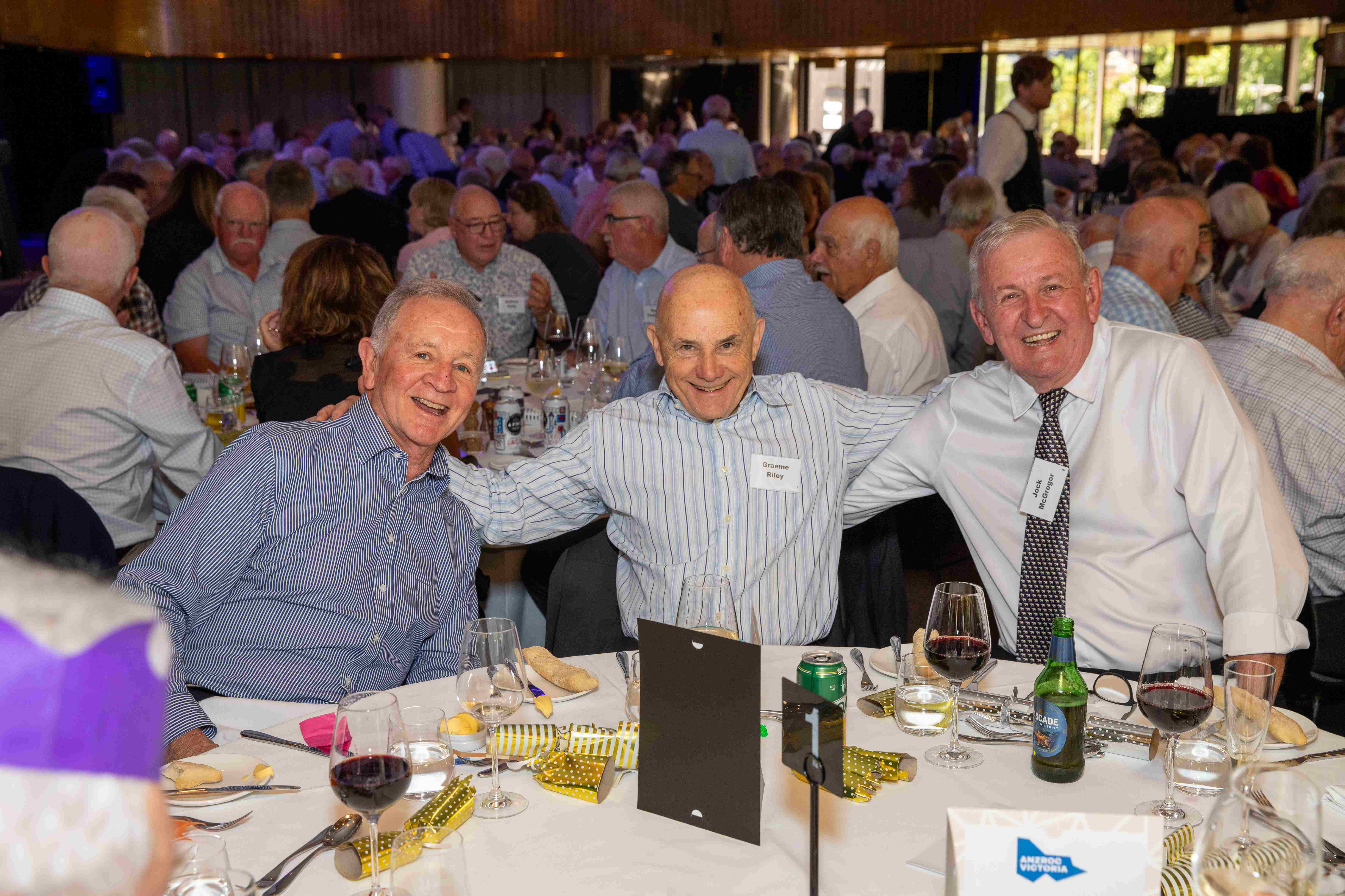 Members of ANZ Retired Officers Club sitting down smiling at camera