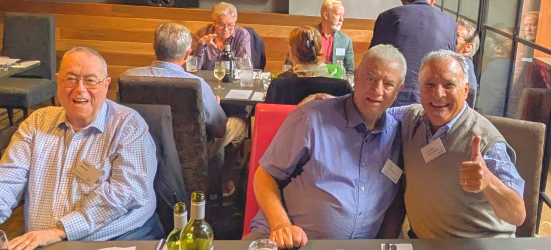 Members of ANZ Retired Officers Club sitting down smiling at camera