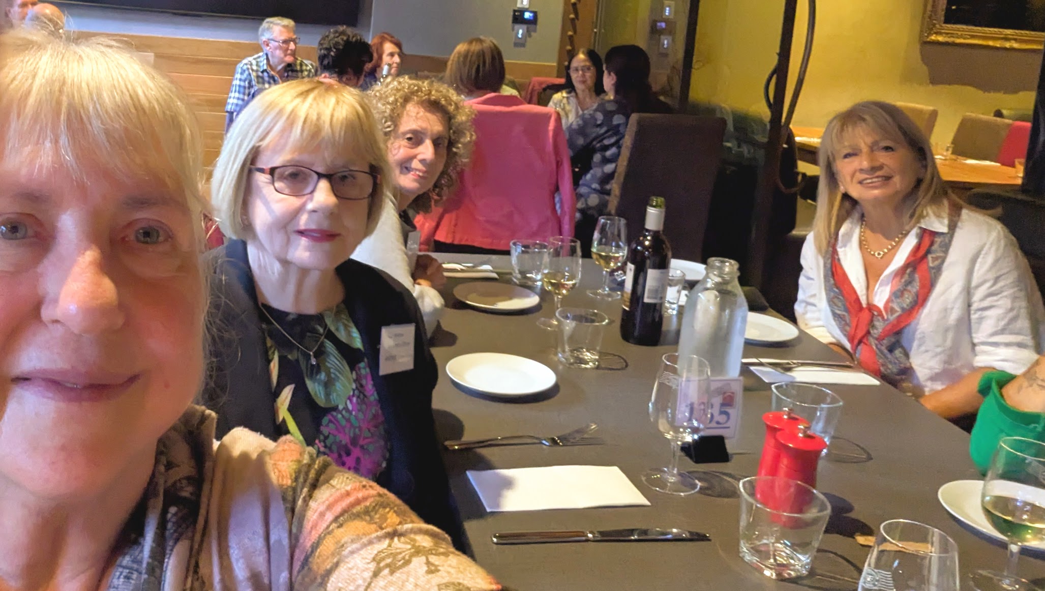 Members of ANZ Retired Officers Club sitting down smiling at camera