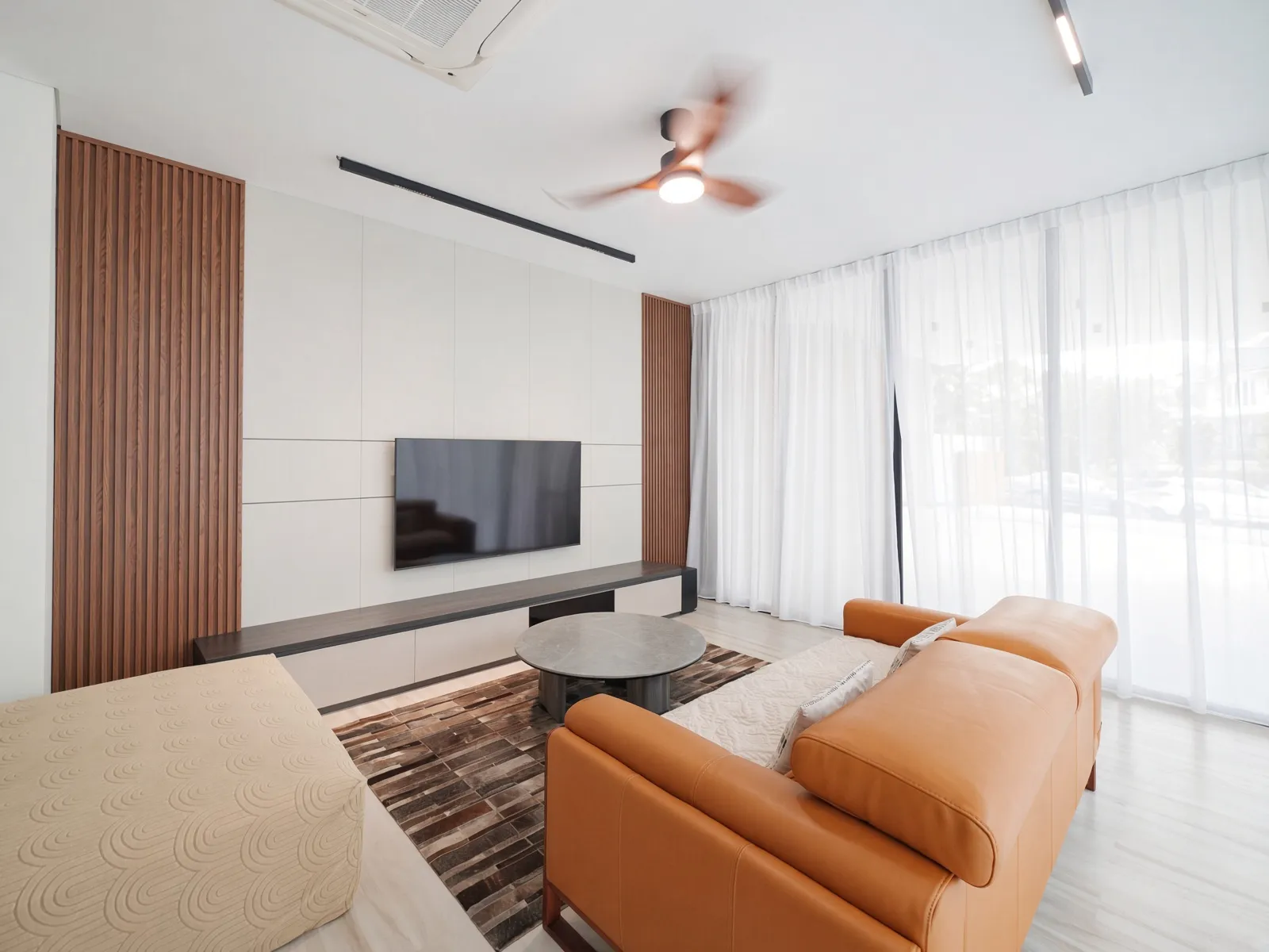 Level 1 entertainment room, a bright open lounge with customised wall panels and full-height windows, made for everyday family living.