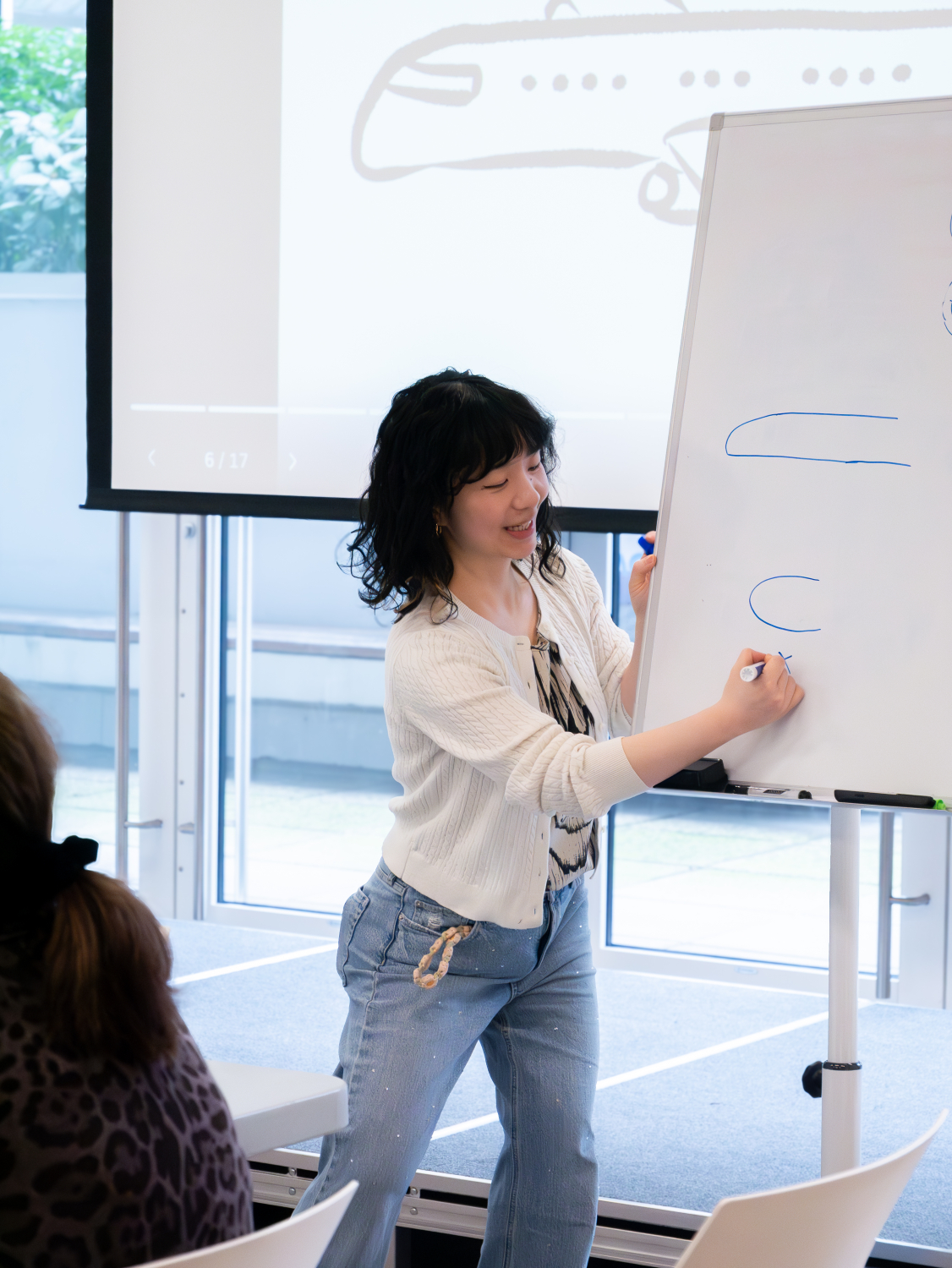 Janice Liu draws on a whiteboard at a comic workshop.