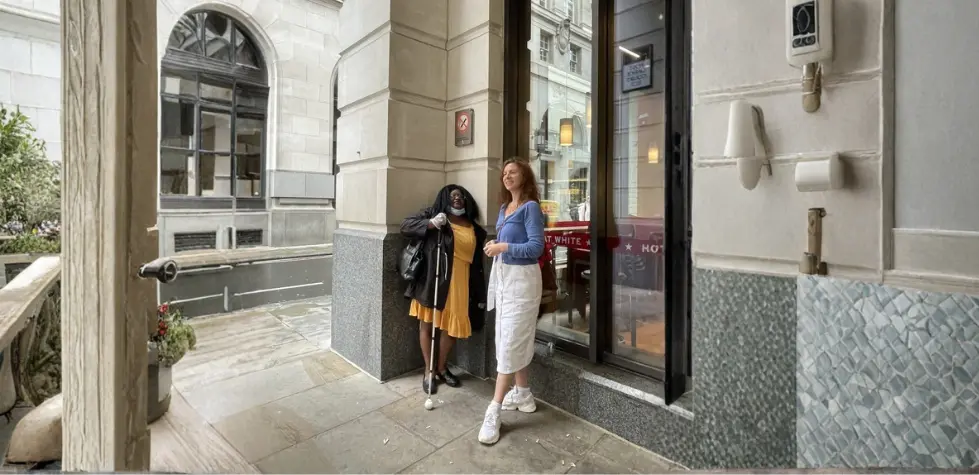 VIP & volunteer standing outside a restaurant 