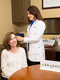Dr. performing hearing test on patient