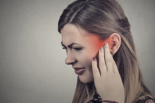 Woman experiencing severe ear pain