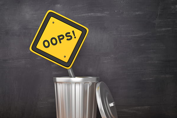 Metal recycling bin with Ooops sign
