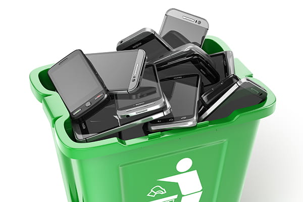recycling bin filled with old mobile phones