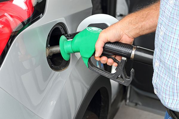 Person filling car with petrol